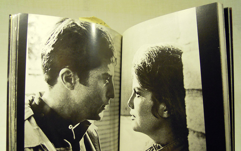Photograph of the ダスティン・ホフマン book open at the pages with a photograph of Dustin looking at another actress